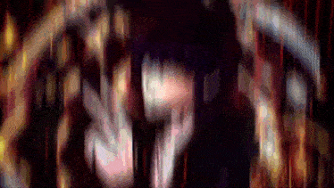 a blurry picture of a person 's face in a dark room .
