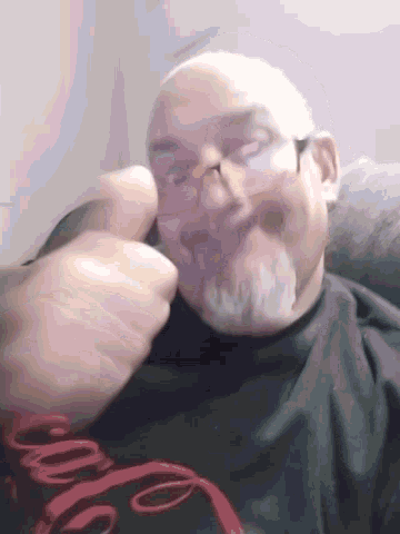 a man wearing a black shirt with a red e on it is laying down