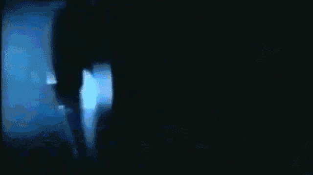 a blue light is shining on a black background .