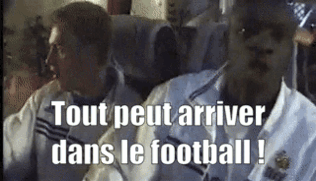 two men are sitting on a bus with the words tout peut arriver dans le football