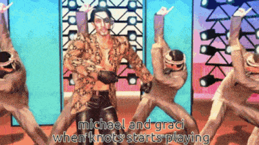 a group of men are dancing in a video game with the words michael and graci when knots starts playing