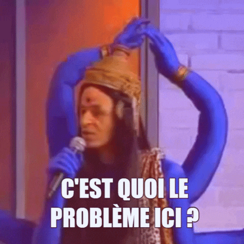 a man in a blue costume is singing into a microphone and says " c'est quoi le probleme ici ? "