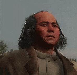 a man with long hair and a bald head is wearing a suit and collared shirt .