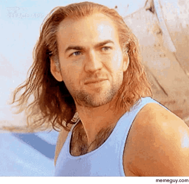 a man with long hair and a beard is wearing a white tank top .