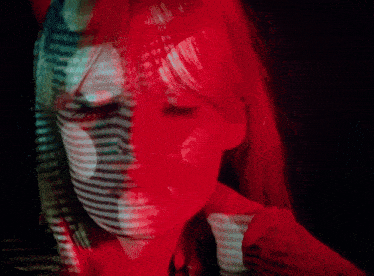 a close up of a woman 's face with red and white stripes on her face
