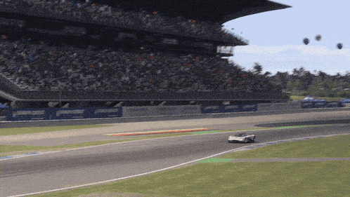 a race car is driving on a track with a banner that says union crest on it