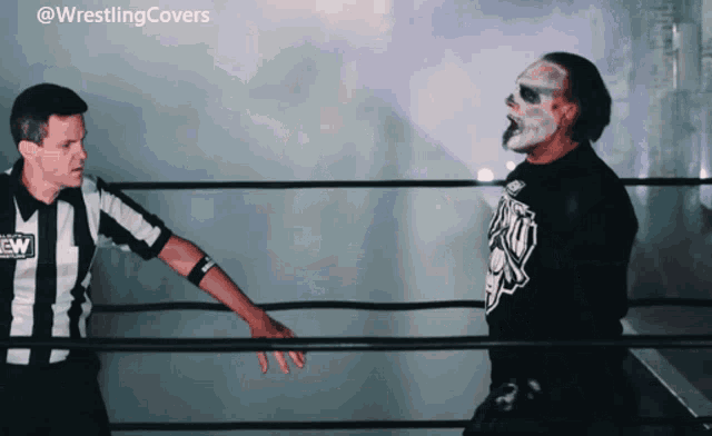 a man in a wrestling ring with a wrestling covers logo