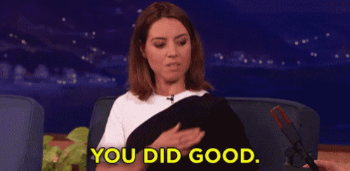 a woman is sitting on a couch and holding a pair of scissors and says `` you did good '' .