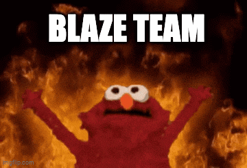 elmo is standing in front of a fire with the words blaze team written above him