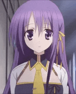 a girl with purple hair and a yellow tie is standing in a hallway and looking at the camera .