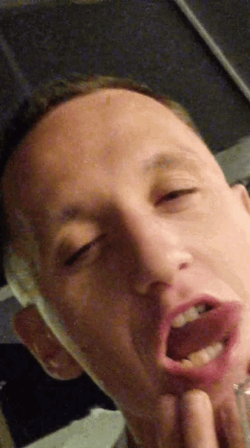 a close up of a man 's face with his eyes closed