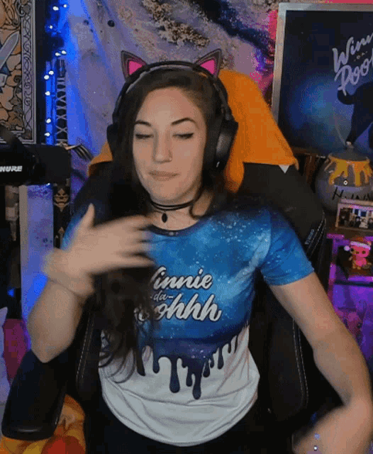 a woman wearing headphones and a t-shirt that says " cannie de shh "