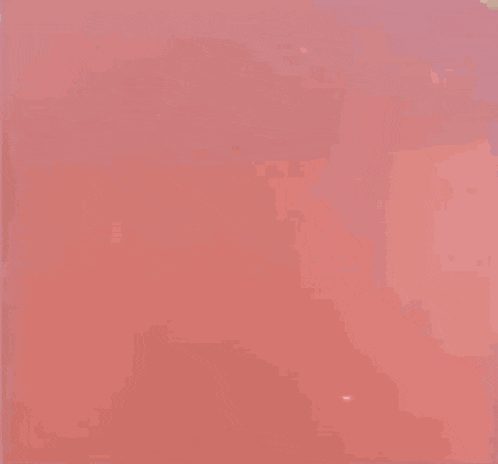 a blurry image of a person walking on a red surface
