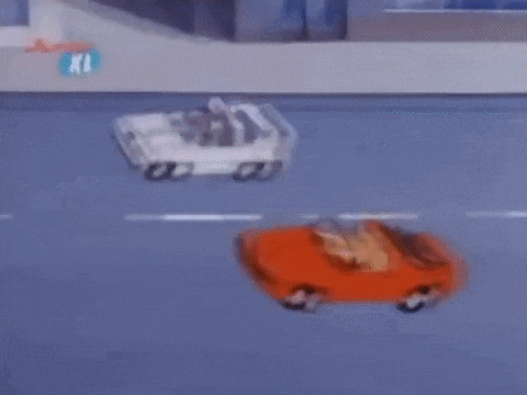 a cartoon car is driving down a street in a parking lot .