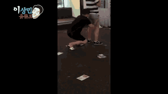 a man is doing push ups on the ground in front of a sign that says eee