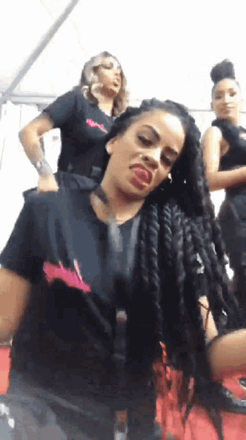 a woman with braids is making a funny face