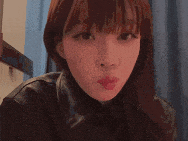 a close up of a person 's face with a blurred background