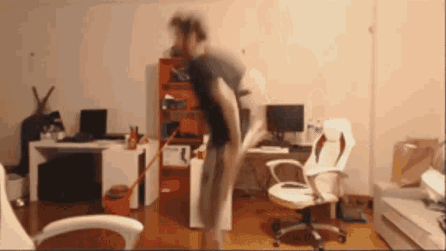 a person standing in a room with a mop