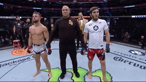 two men are standing next to each other in a boxing ring sponsored by a company called crypto.com