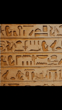 a close up of a wall with ancient writing on it