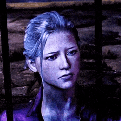 a close up of a woman 's face with blue hair