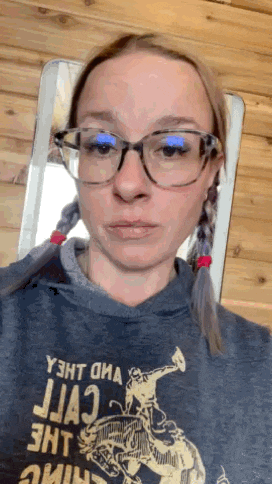 a woman wearing glasses and a t-shirt that says y3ht ona