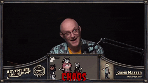 a man stands in front of a screen that says adventure is night and game master jack packard