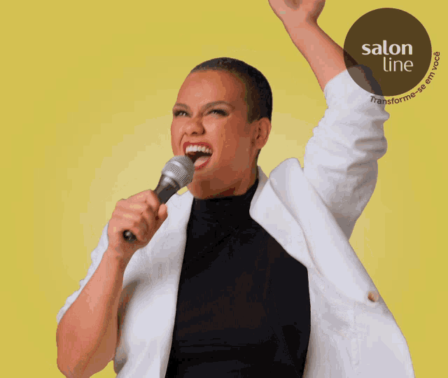 a woman is singing into a microphone with a salon line logo in the background