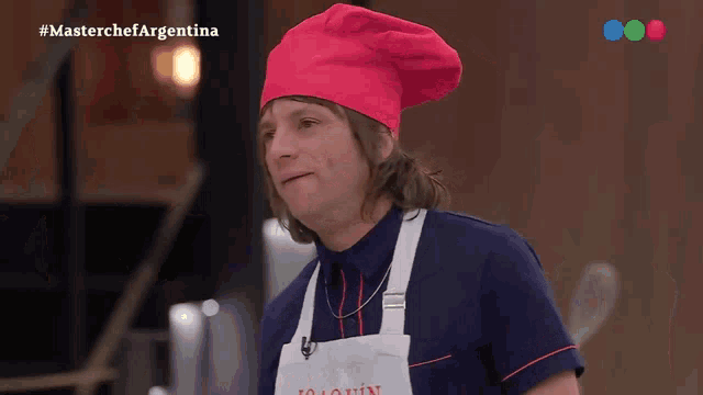 a man wearing a chef 's hat and apron is on a masterchef argentina show