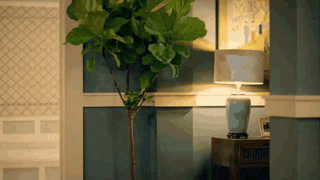 a lamp sits on a table next to a tree
