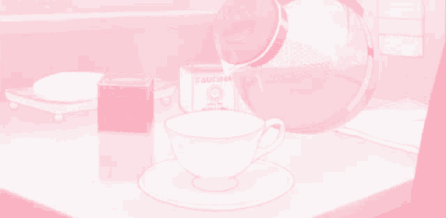 a box of sugar sits on a table next to a cup and saucer