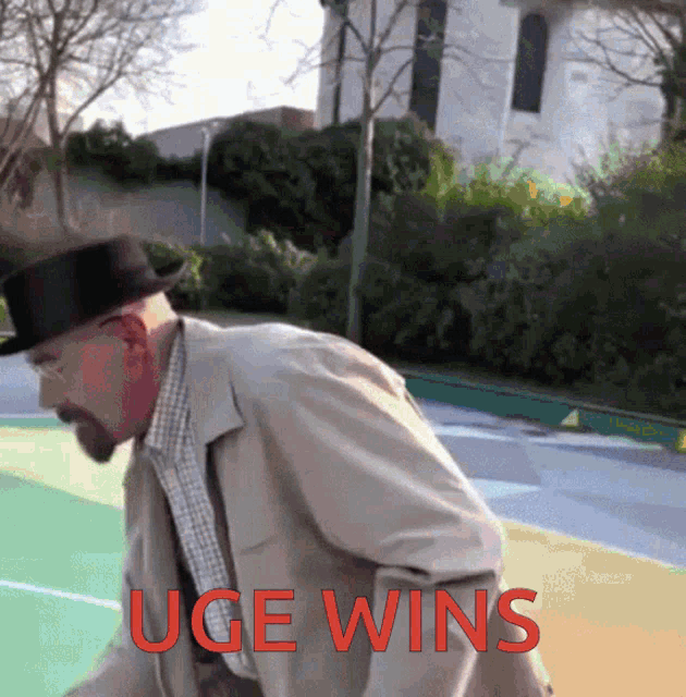 a man wearing a top hat and a trench coat is standing on a basketball court with the words " uge wins " in red
