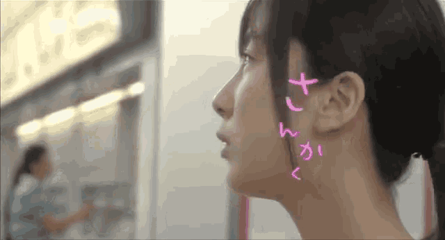 a close up of a woman 's face with chinese writing on her face