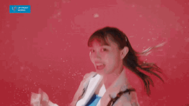 a woman is standing in front of a red background with chemical formulas and the word upfront works on it