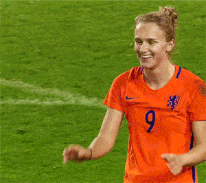 a woman in an orange shirt with the number 7 on it is hugging another woman in an orange shirt