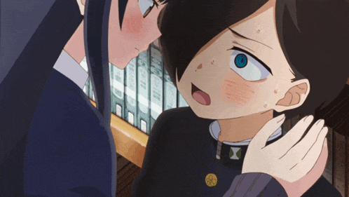 a girl with a blue eye is touching a boy 's forehead
