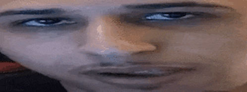 a close up of a man 's face with his eyes closed .