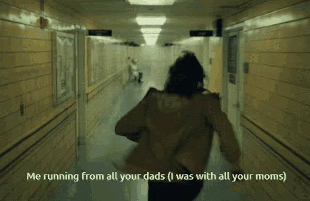a woman is running down a hallway with the caption " me running from all your dads "
