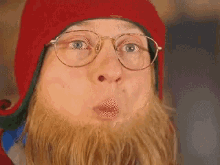 a close up of a person wearing glasses and a hat