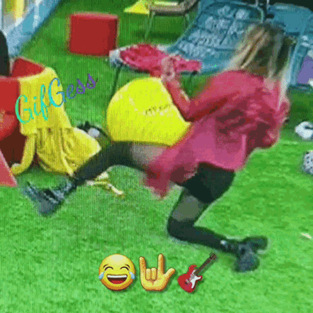 a woman in a pink dress is kneeling on the grass with a guitar and a smiley face with a laughing face