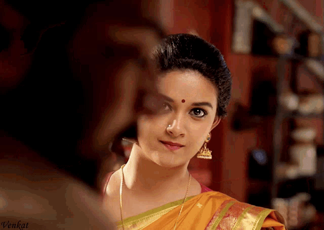 a close up of a woman 's face with the name venkat on the bottom left