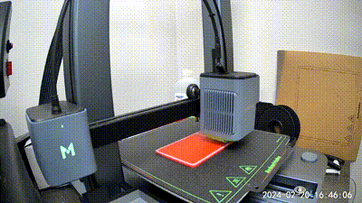 a 3d printer is printing a piece of paper on a table .