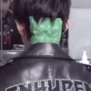 a person with a green glove on their neck .