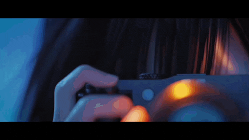 a close up of a person holding a camera with # 01 falling written on it