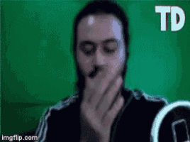 a man is covering his mouth with his hands and the word td is visible in the corner