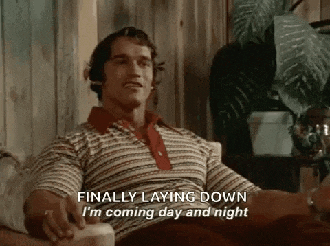 arnold schwarzenegger is sitting in a chair and says `` finally laying down i 'm coming day and night ''