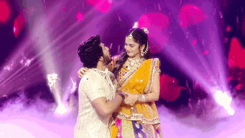 a man and a woman are dancing together on a stage .