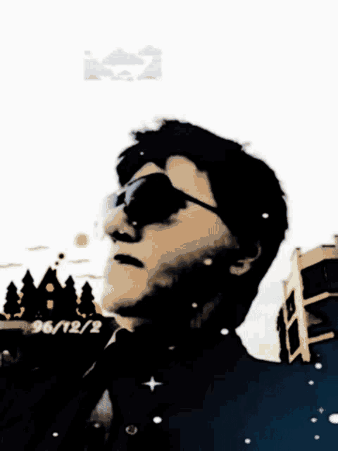 a man wearing sunglasses has the date of 96/12/2 on the bottom