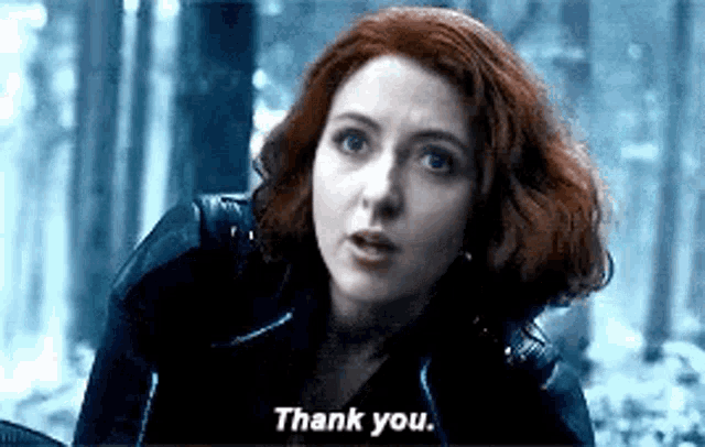 black widow is saying thank you in a forest .