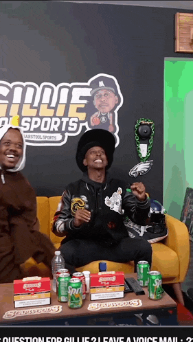 a man is sitting on a couch in front of a sign that says ' gillie sports ' on it